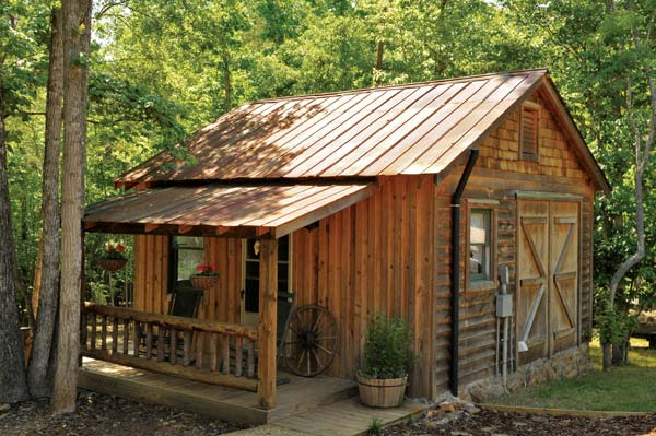 This small "shed" houses a storage closet for the home's outdoor kitchen.